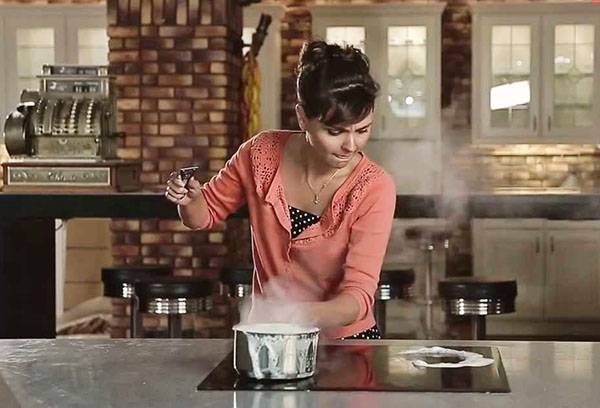 Girl cooking on a glass-ceramic stove