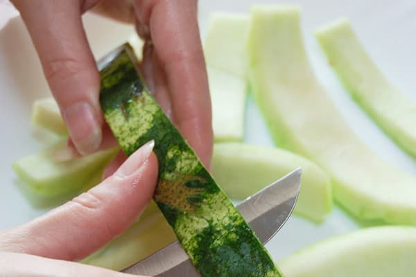 Limpiar cáscaras de sandía para hacer frutas confitadas.