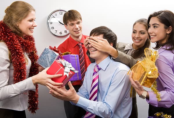 Colleagues congratulate a man on his birthday