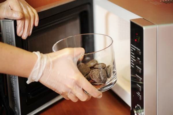 The confectioner puts chocolate in the microwave