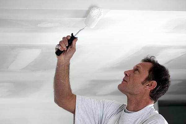 Man painting the ceiling