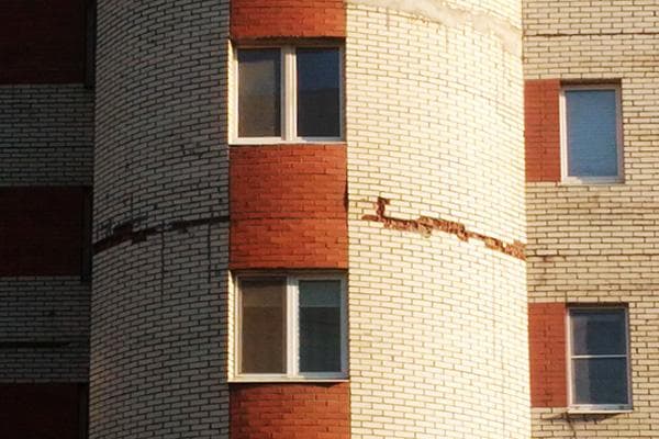 Crack on the facade of a brick high-rise building