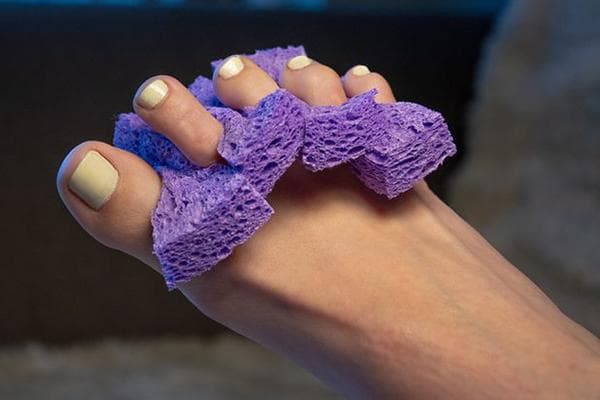 Separador de dedos durante pedicura hecho de esponja
