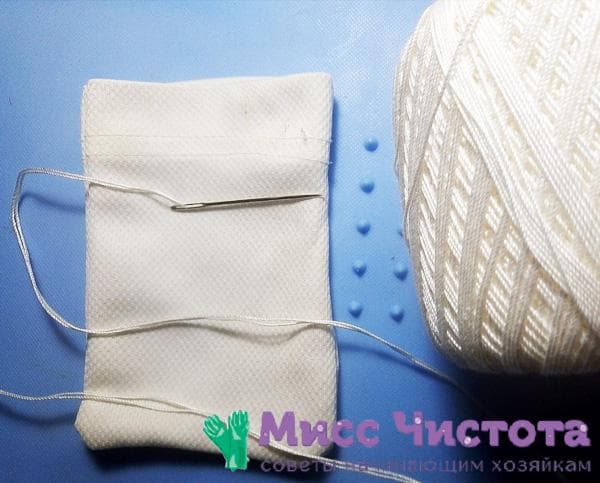 white bag, needle and thread