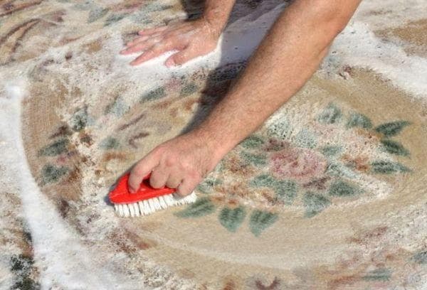 Limpiar la alfombra con detergente en polvo.